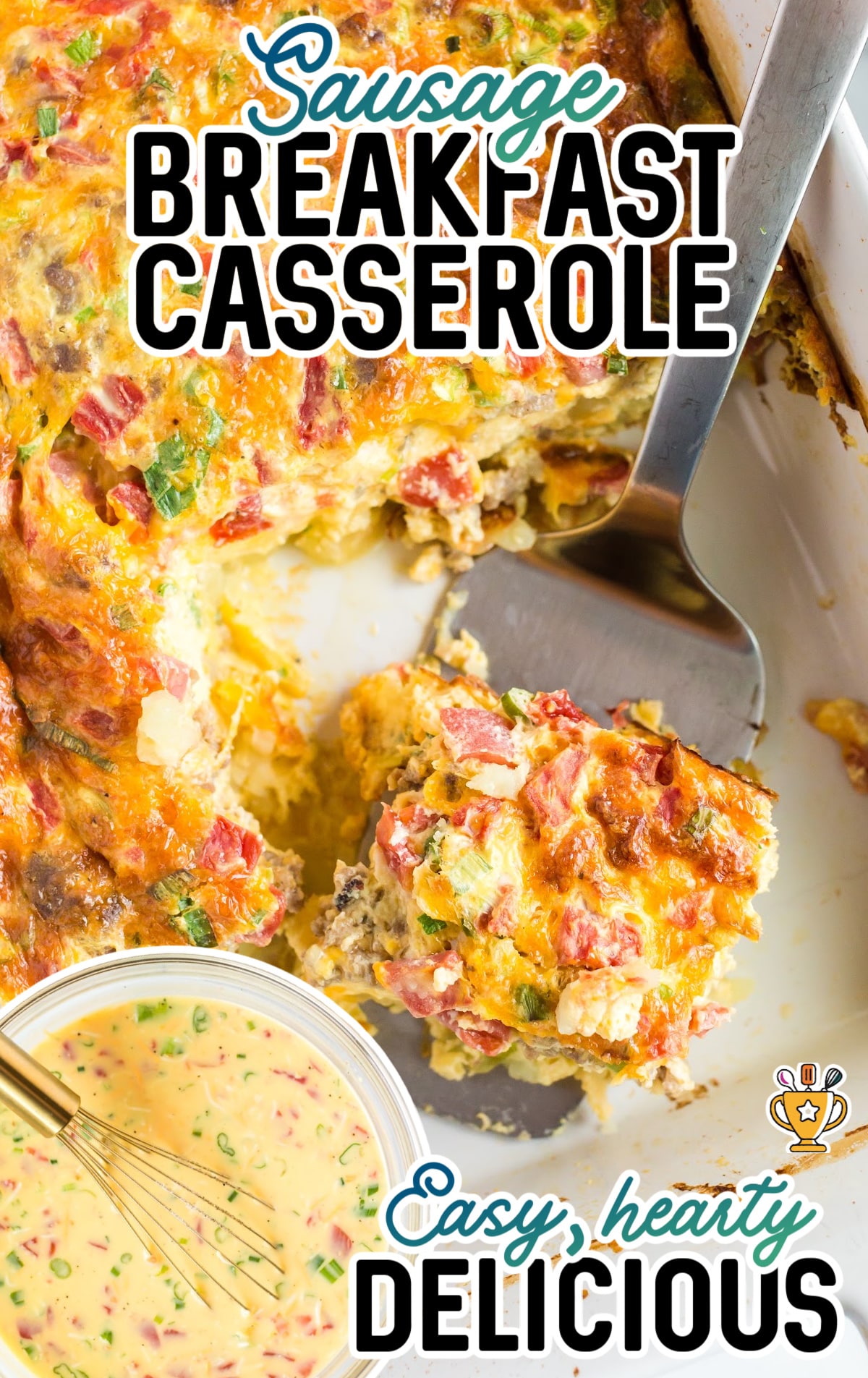 Sausage Breakfast Casserole in a baking dish with a spatula holding a piece of it