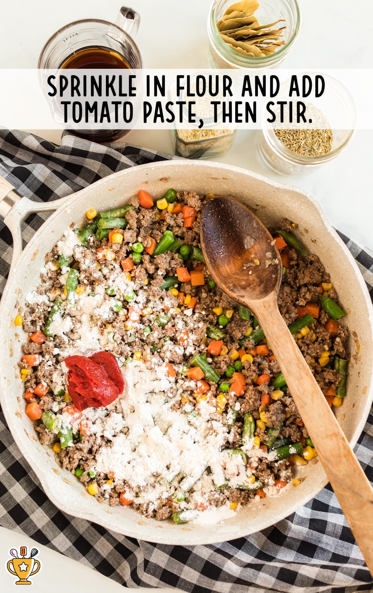 flour and tomato paste added in a skillet