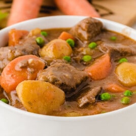 a white serving bowl with Beef Stew