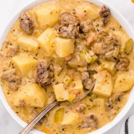 Cheeseburger Soup in a white bowl with a spoon