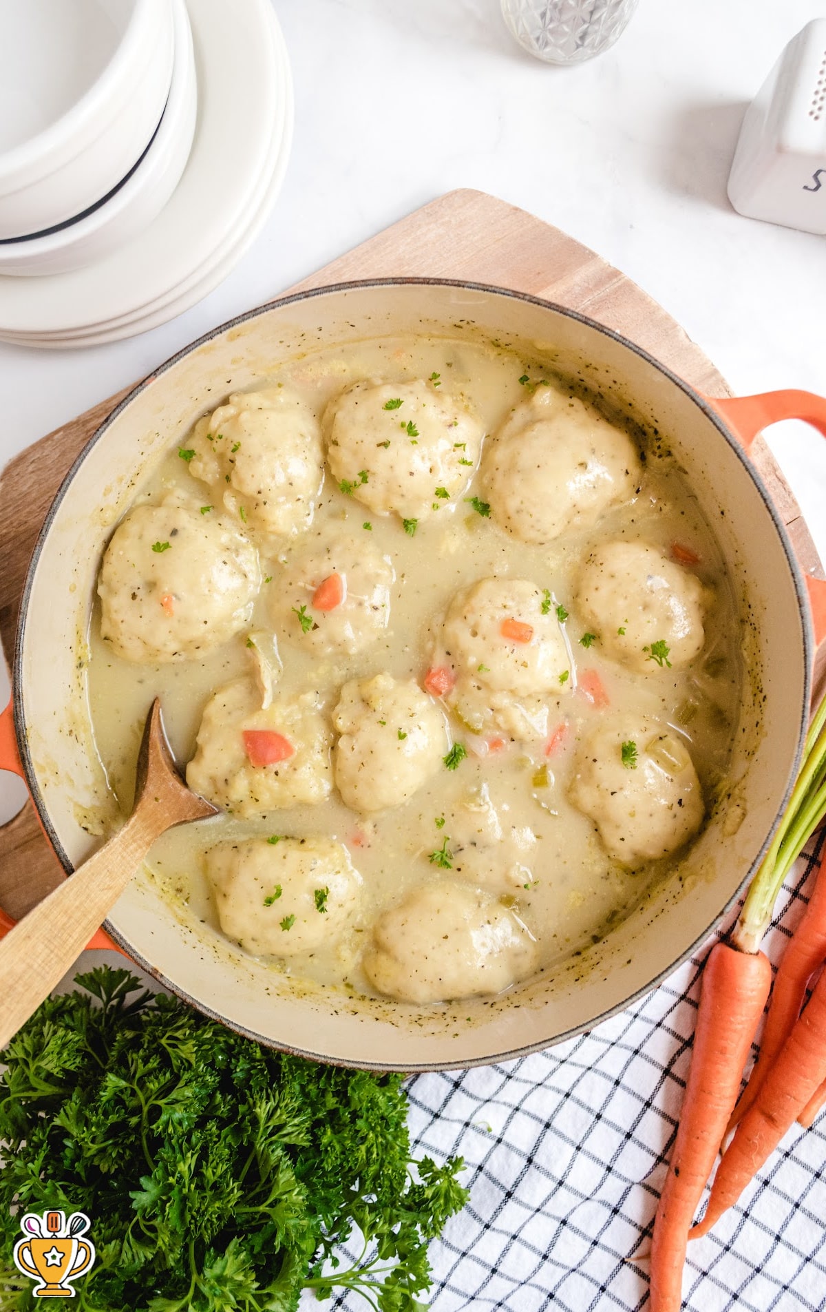 Chicken and Dumplings in a bowl with a wooden spoon