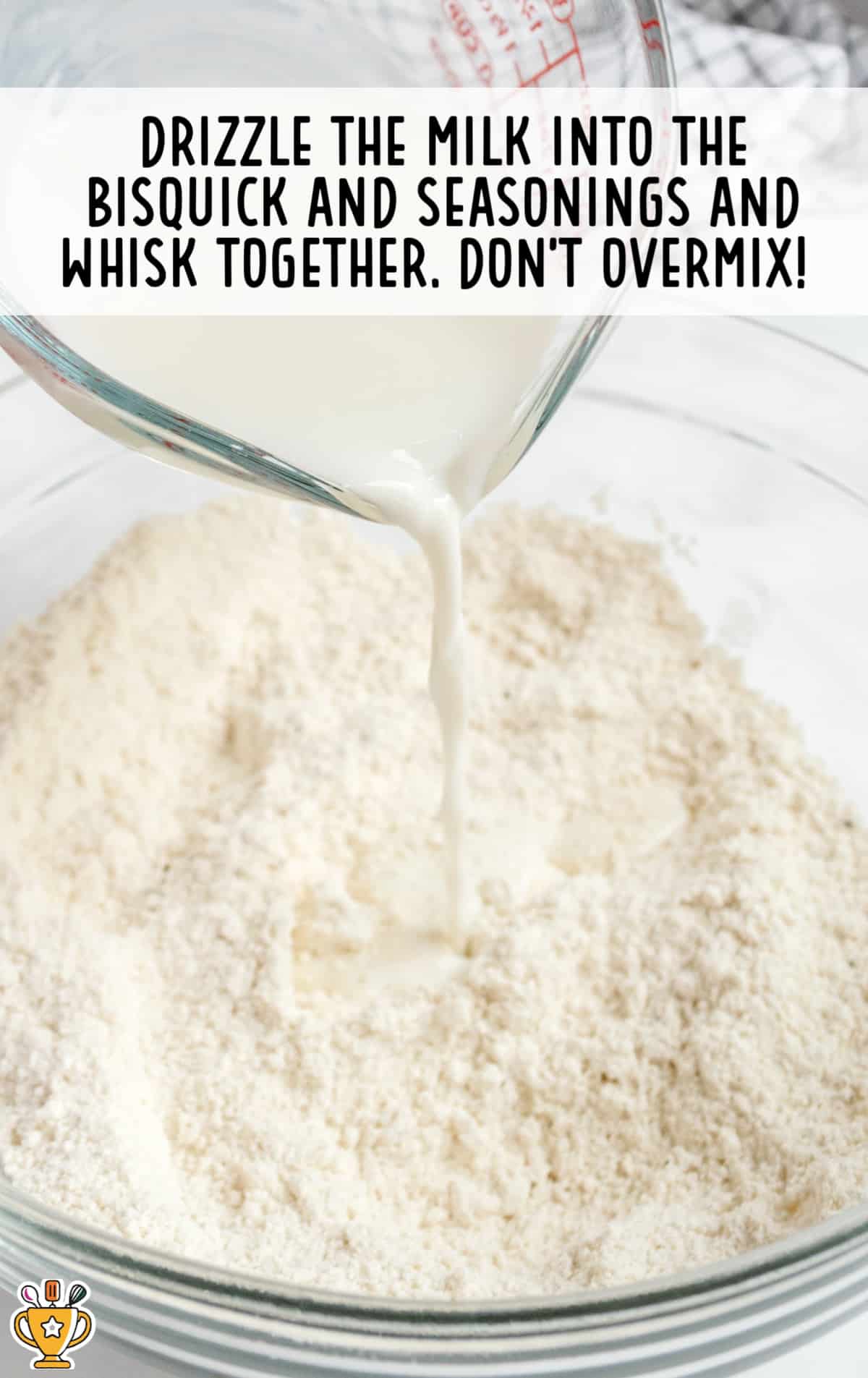 Milk added into the bisquick and seasonings and whisked together in a clear bowl