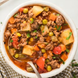 a bowl full of Hamburger Soup with a spoon