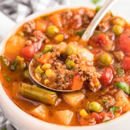 A bowl full of Hamburger Soup with a spoon