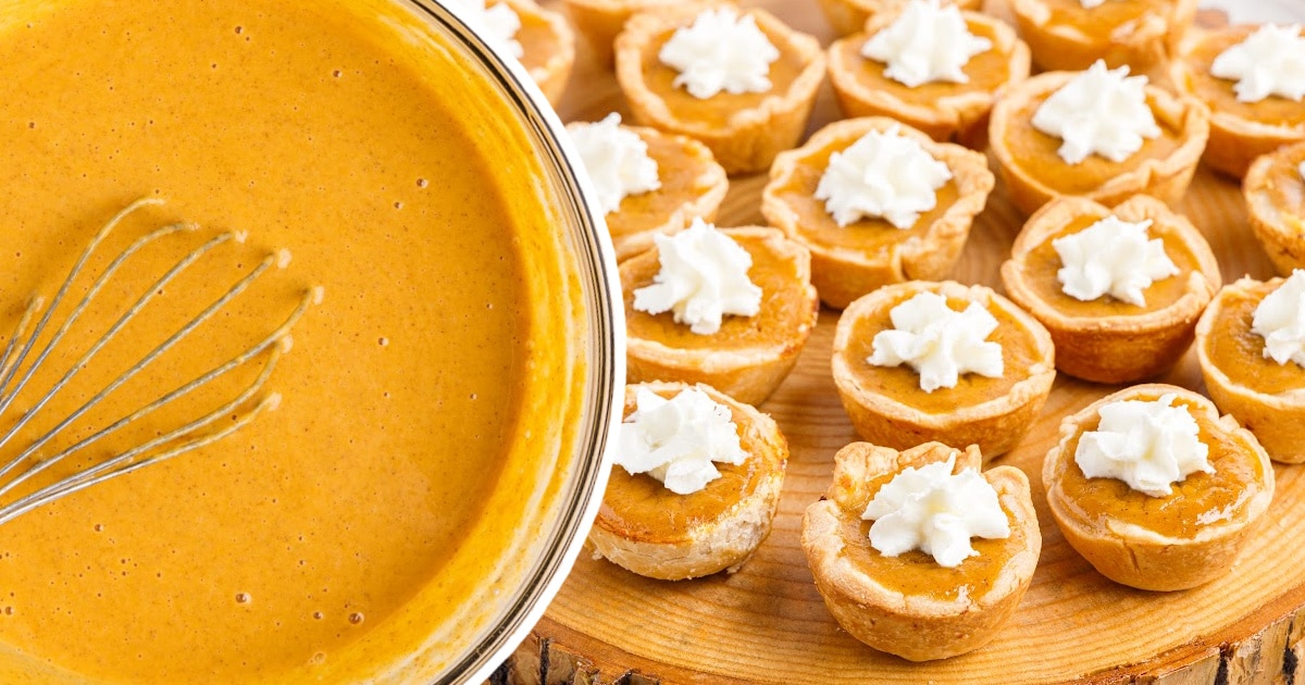 Mini Pumpkin Pies on a wooden board and some filling in a clear bowl