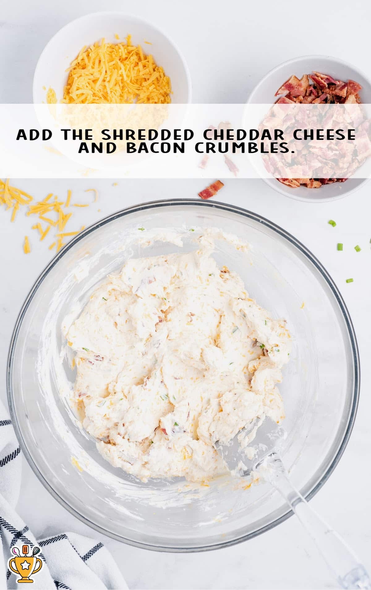 shredded cheddar cheese and bacon crumbles mixed in a bowl