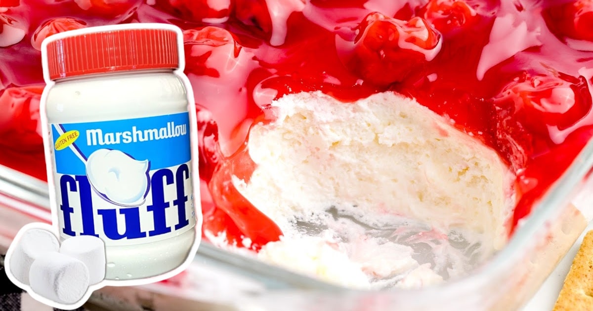 Cherry Cheesecake Dip in a baking dish with a jar of marshmallow fluff on the side