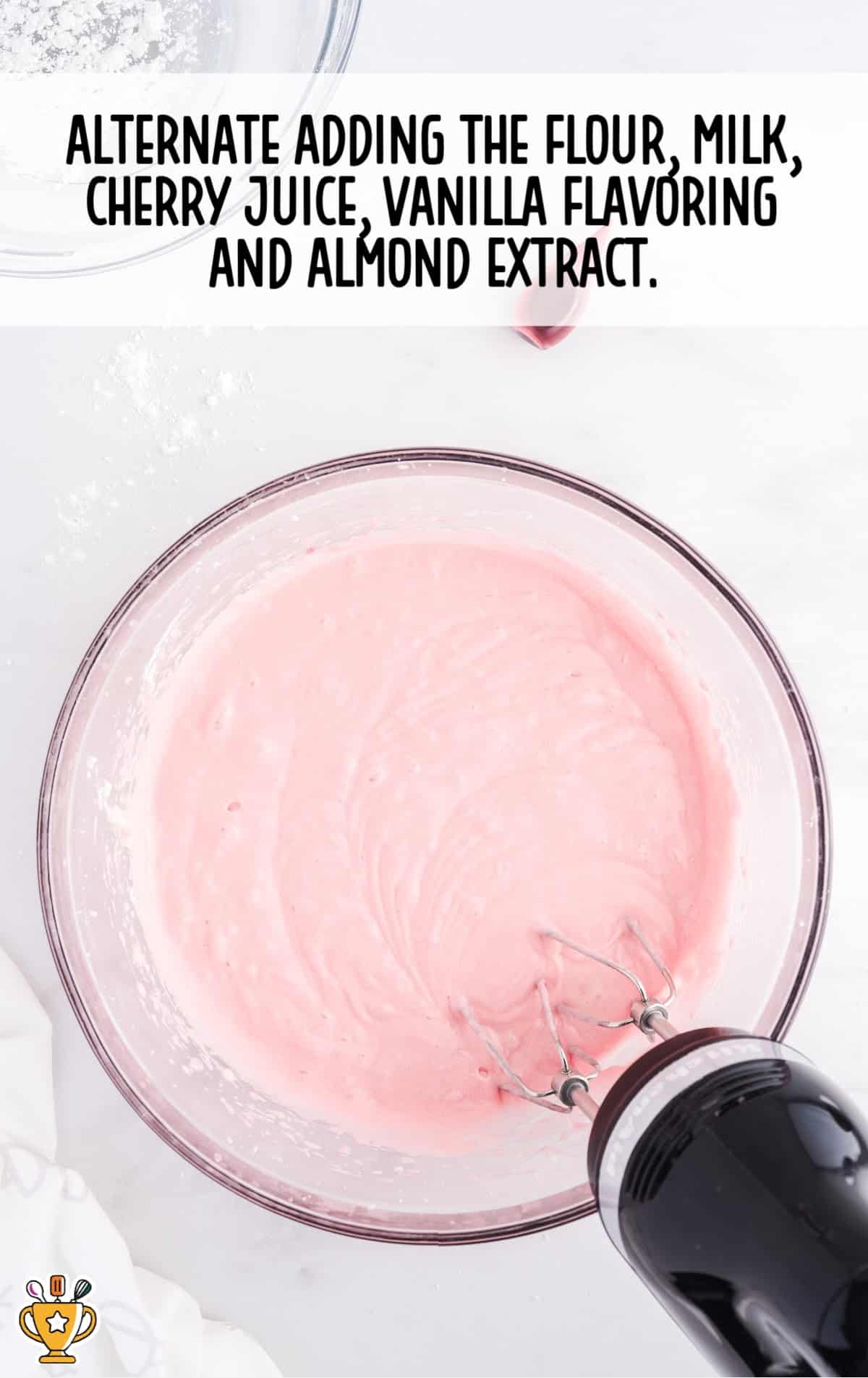 flour, milk, cherry juice, vanilla flavoring and almond extract added in a bowl