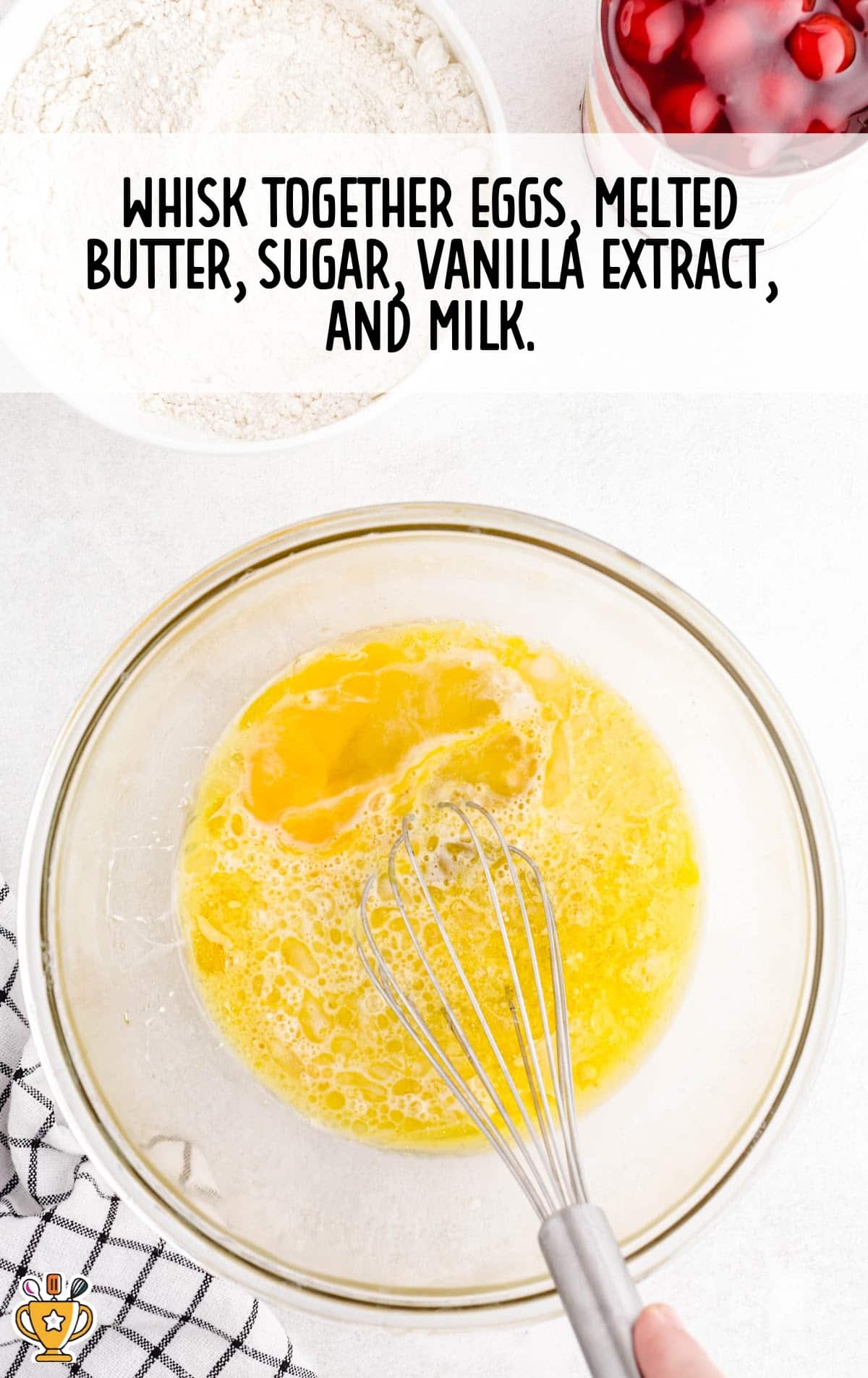 eggs, melted butter, sugar, vanilla extract and milk added in a bowl with a whisker
