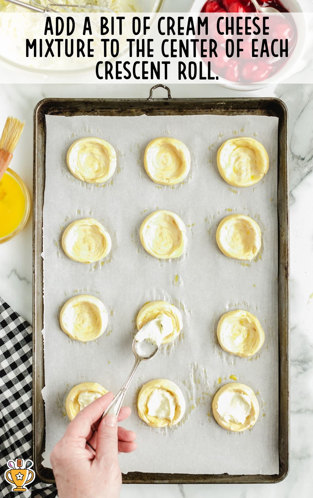 adding cream cheese mixture to the center of each crescent roll