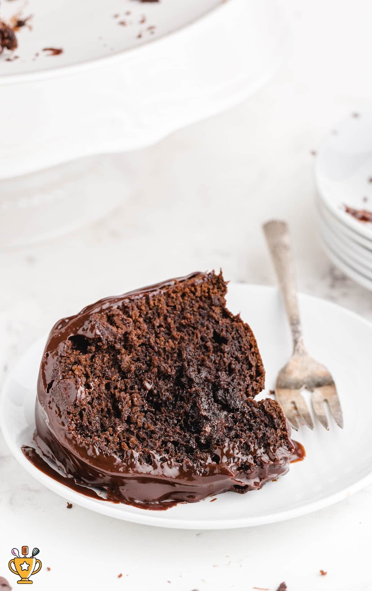 a piece of Chocolate Brownie Cake on a plate with a fork