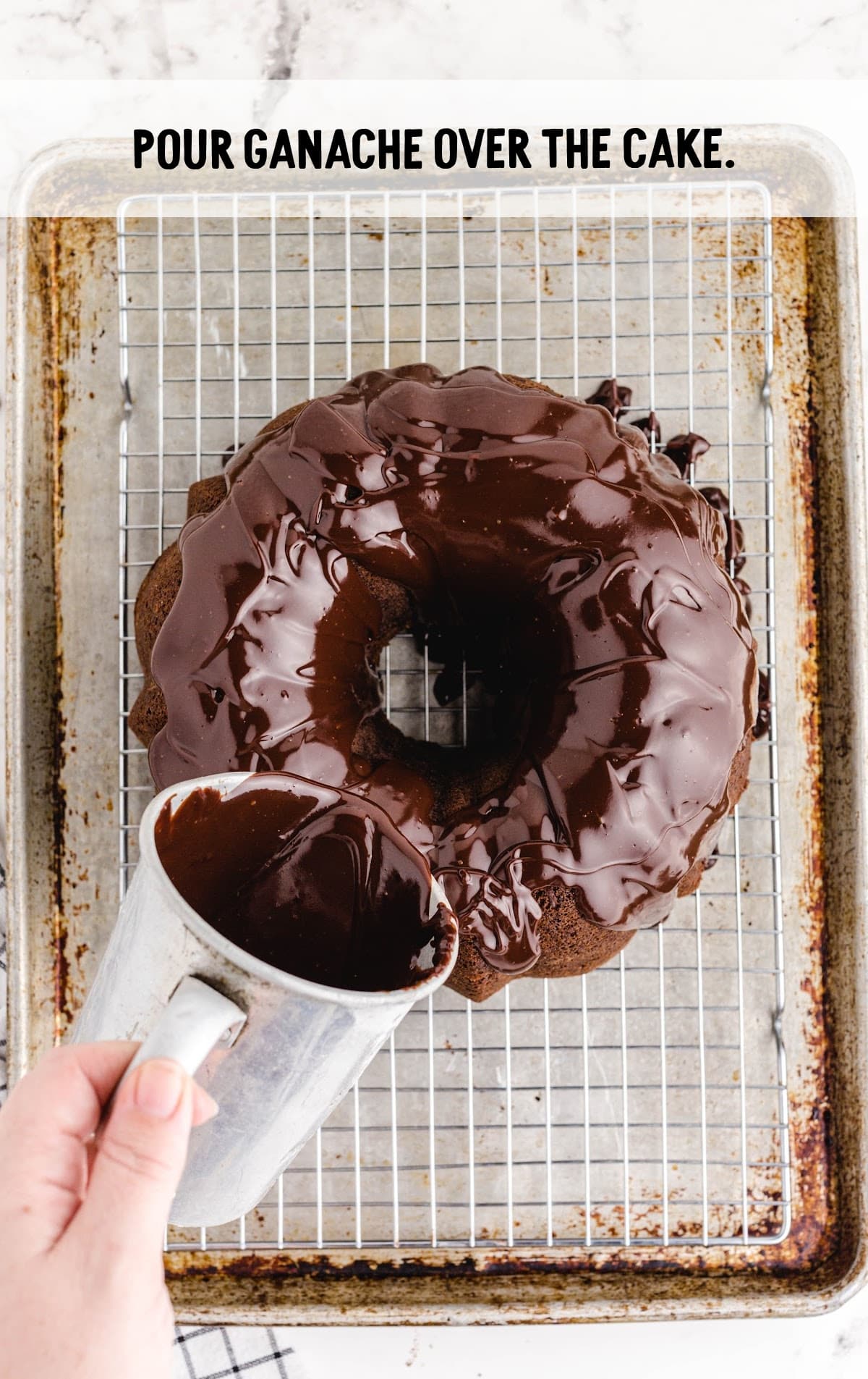Pouring ganache over the cake