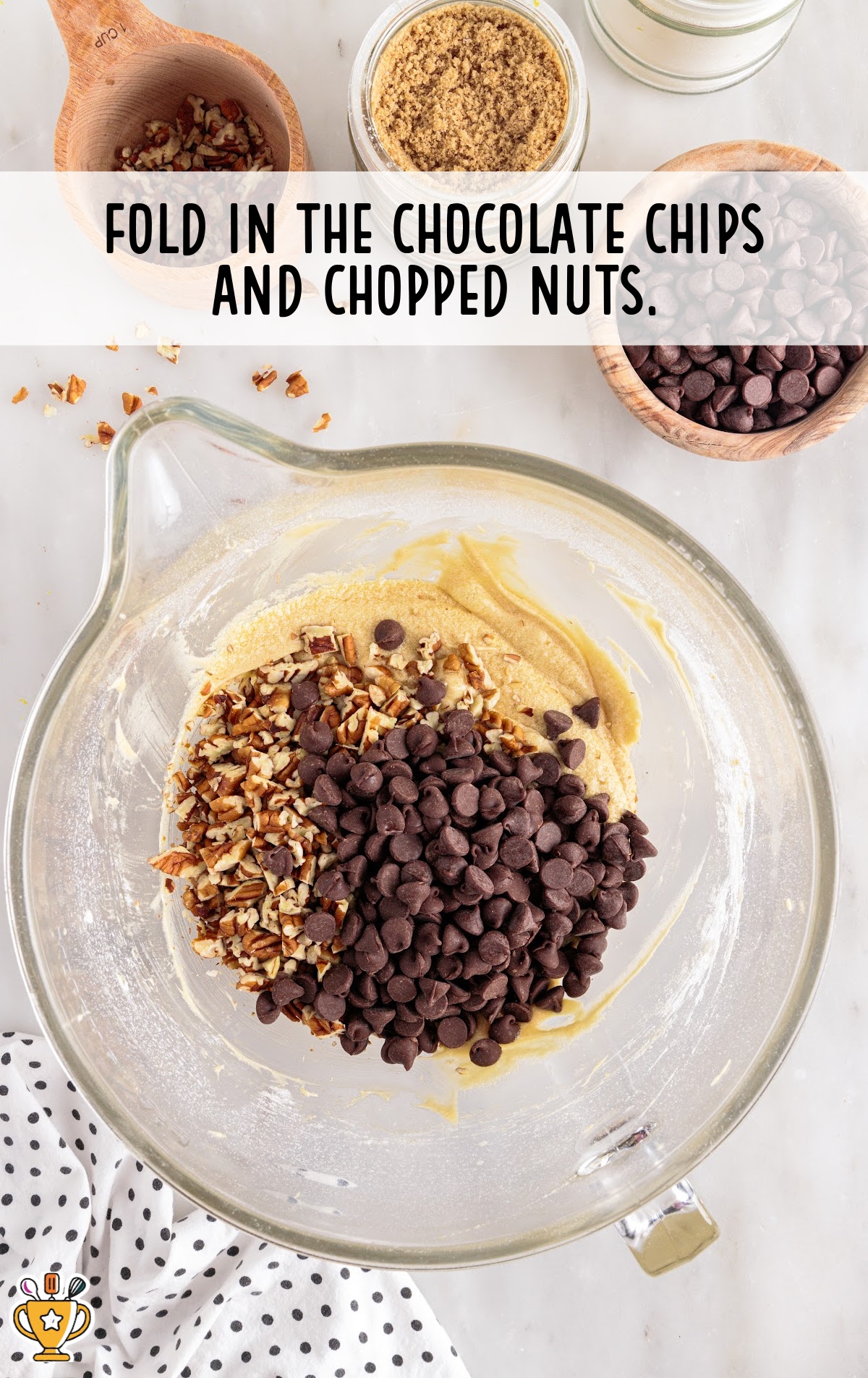 folding in the chocolate chips and chopped nuts in a bowl