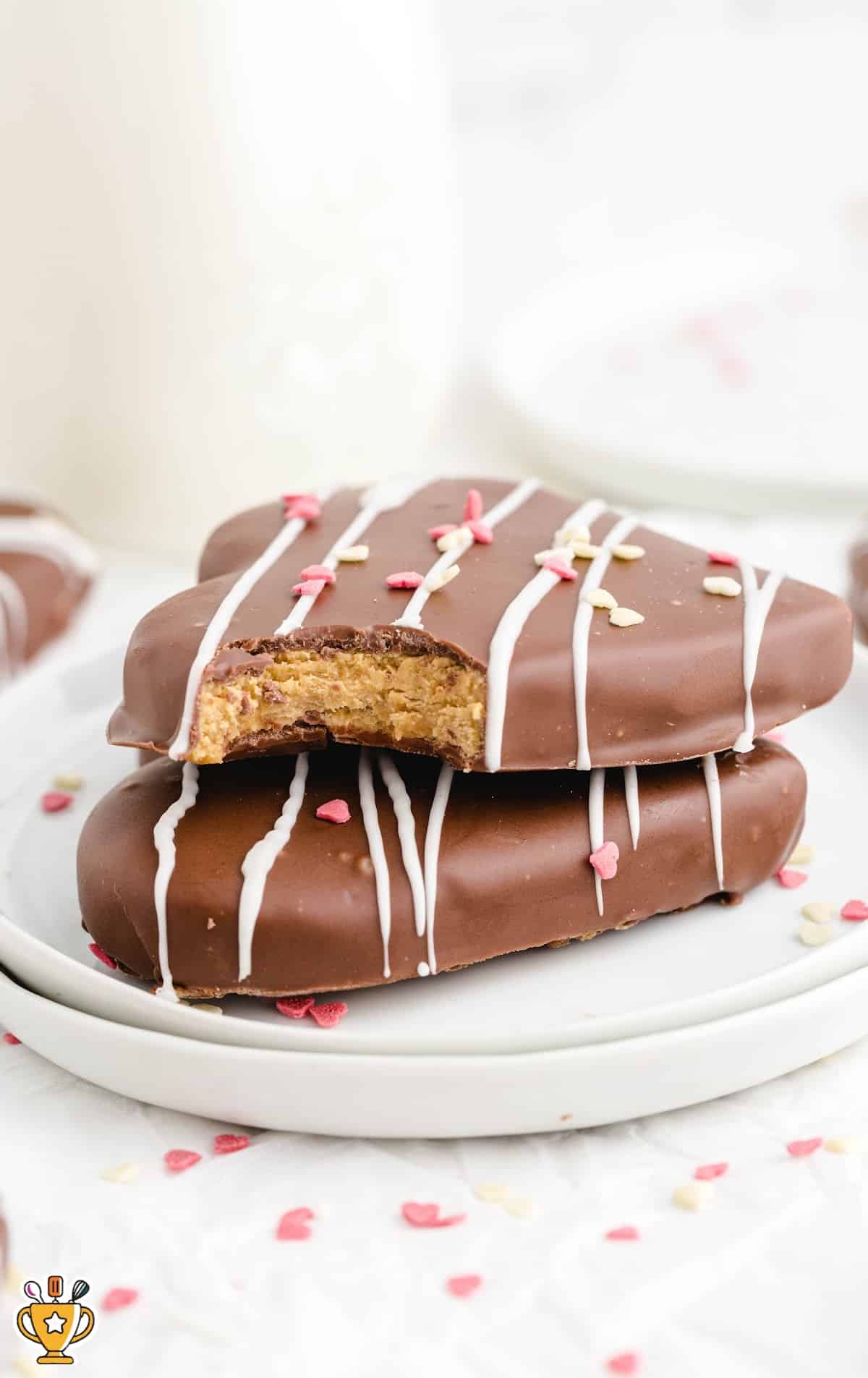 two Chocolate Covered Peanut Butter Hearts on a plate
