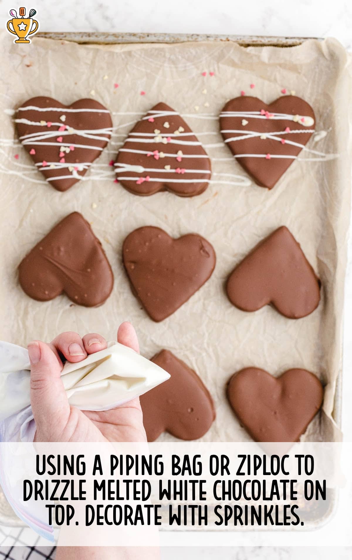 using a piping bag to drizzle melted white chocolate on top and decorating with sprinkles