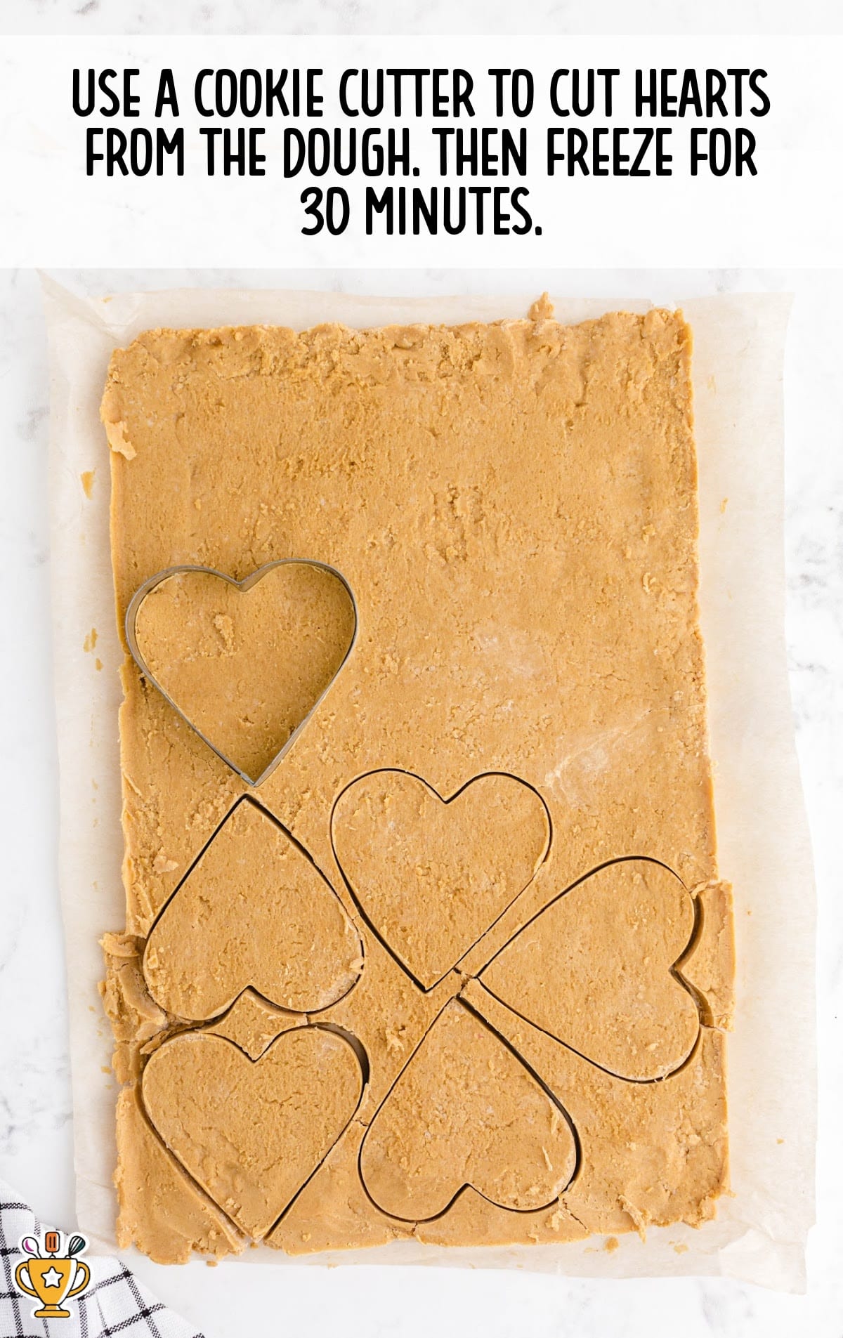 cutting the hearts from the dough with a cookie cutter