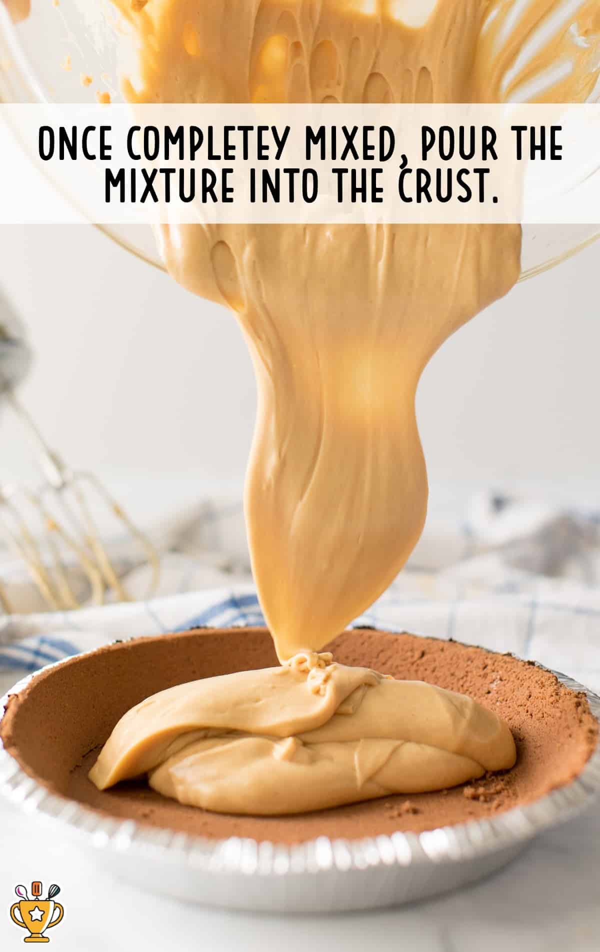 pouring the Chocolate Peanut Butter Pie into the crust