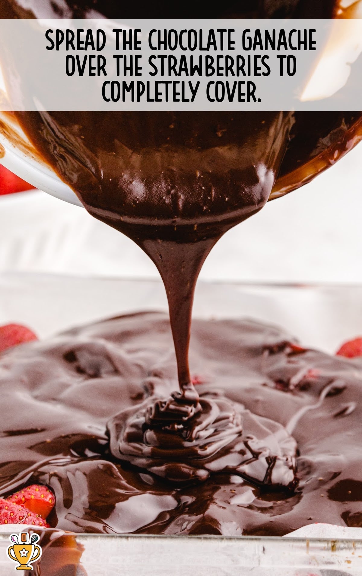 pouring chocolate ganache over the strawberry
