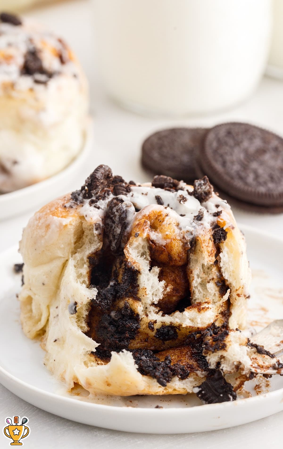 a piece of Cookies and Cream Cinnamon Rolls on a white plate