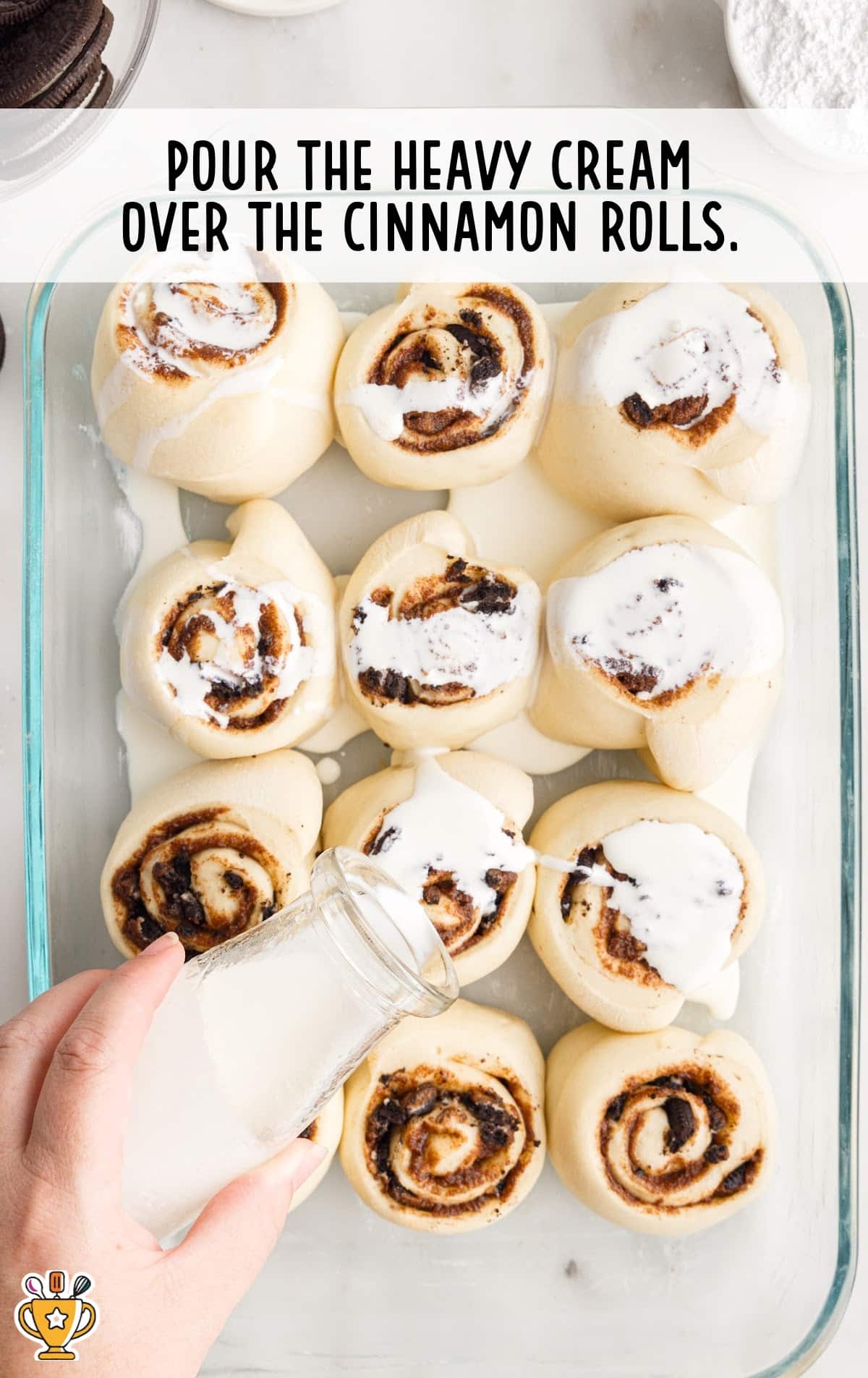 The cream is poured over the cinnamon rolls