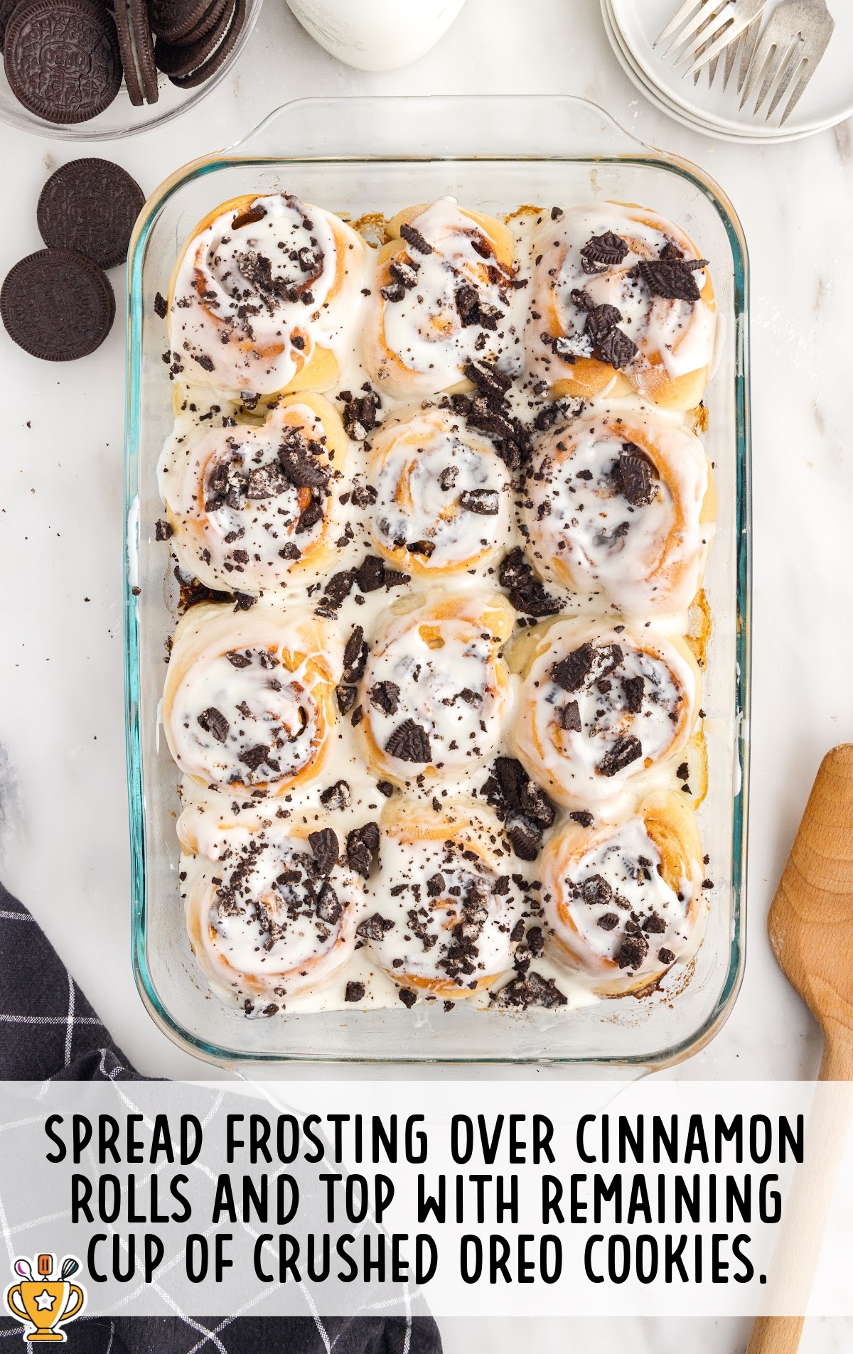 The frosting is spread over the Cookies and Cream Cinnamon Rolls.