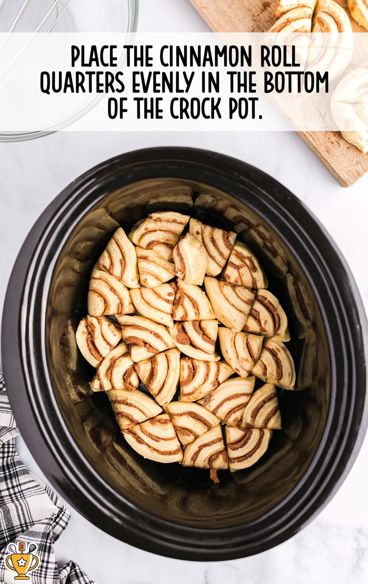 cinnamon roll quarters placed in the bottom of the crockpot