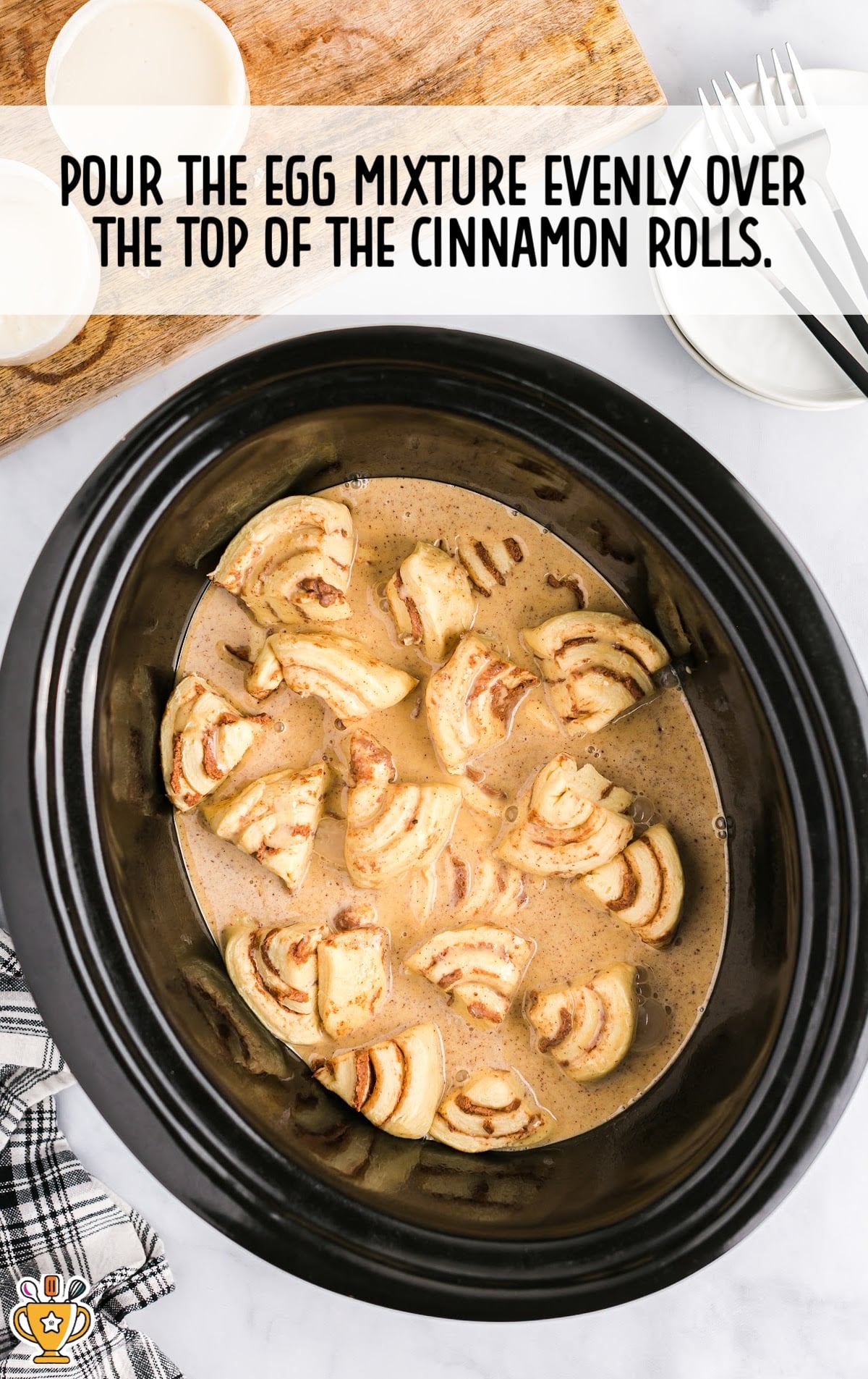 egg mixture poured over the top of the cinnamon rolls
