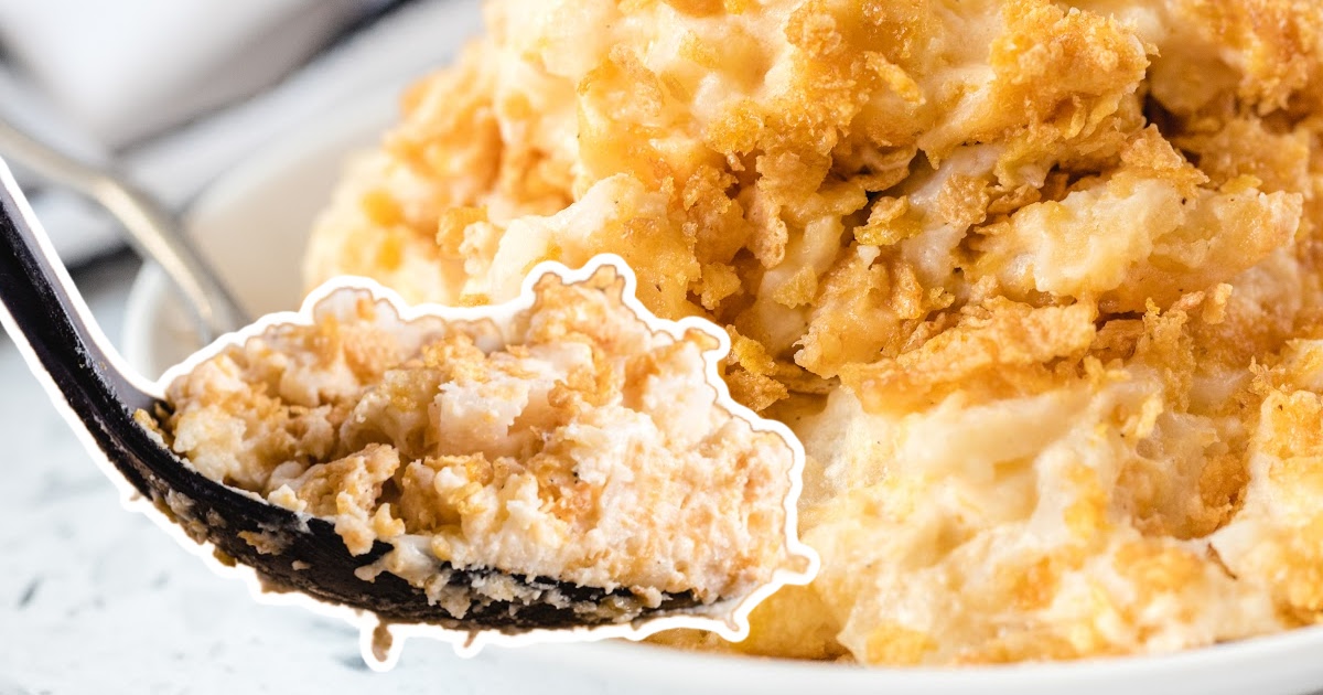 a black spoon holding some Funeral Potatoes