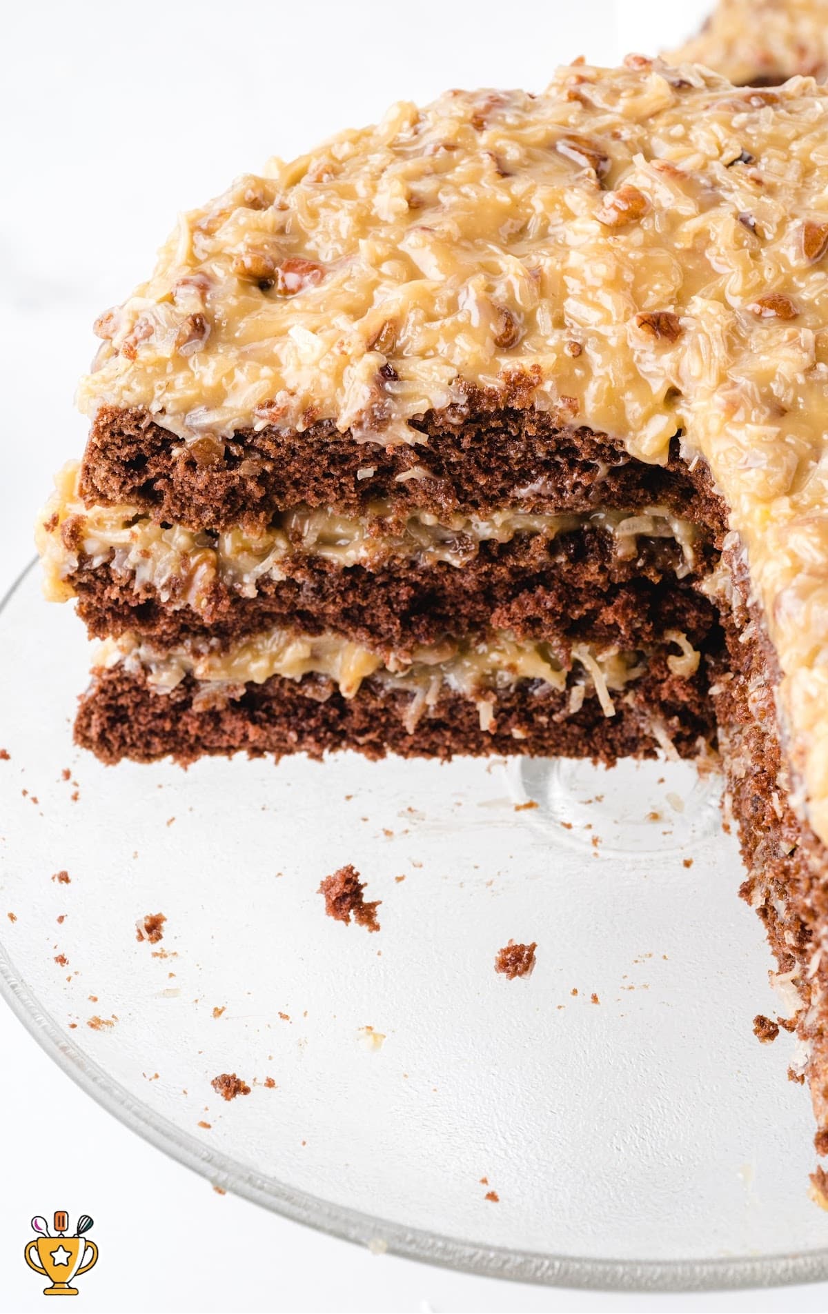 German Chocolate Cake on a cake stand with a piece missing
