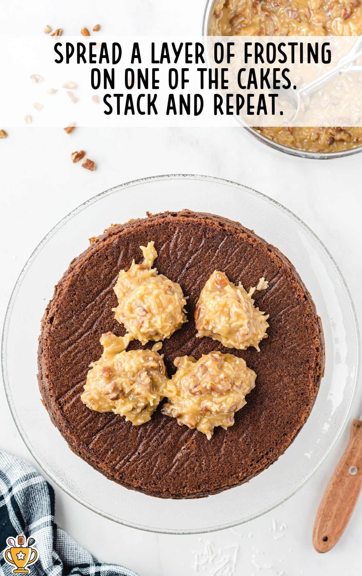 Spreading a layer of frosting on one of the cakes