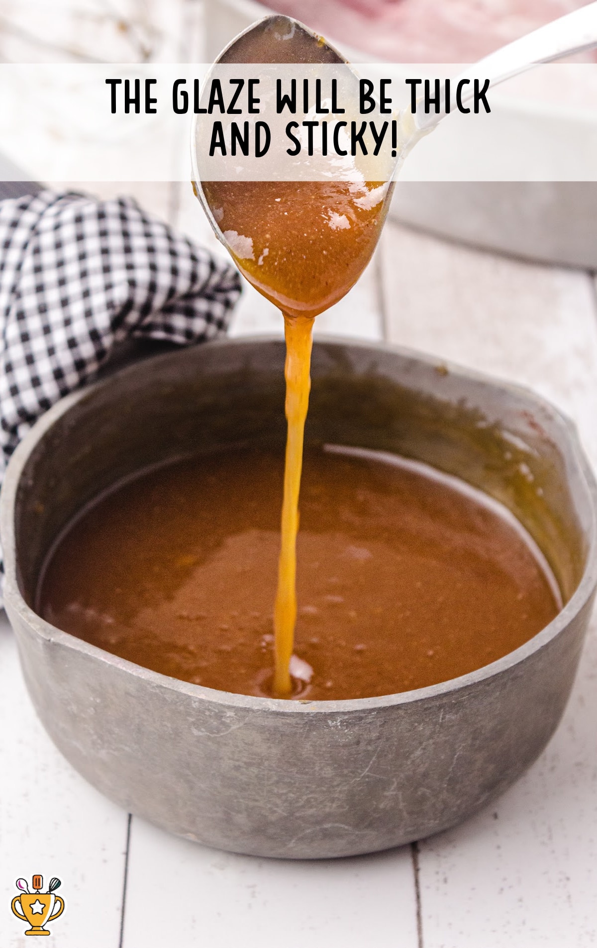glaze in a bowl with a spoon holding some glaze