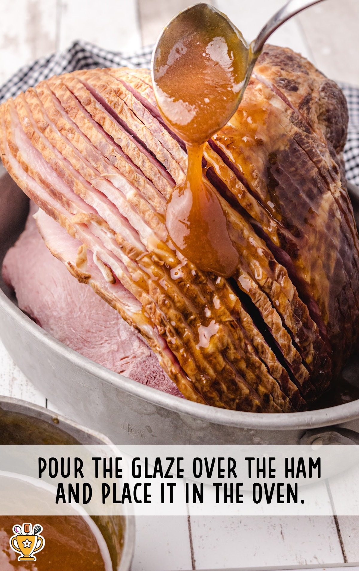 pouring the glaze over the ham using a spoon