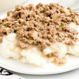 Hamburger Gravy served on a plate with mashed potatoes