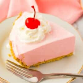 a piece of Strawberry Jello Pie on a white plate with a fork