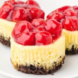 three Mini Cherry Cheesecake on a plate