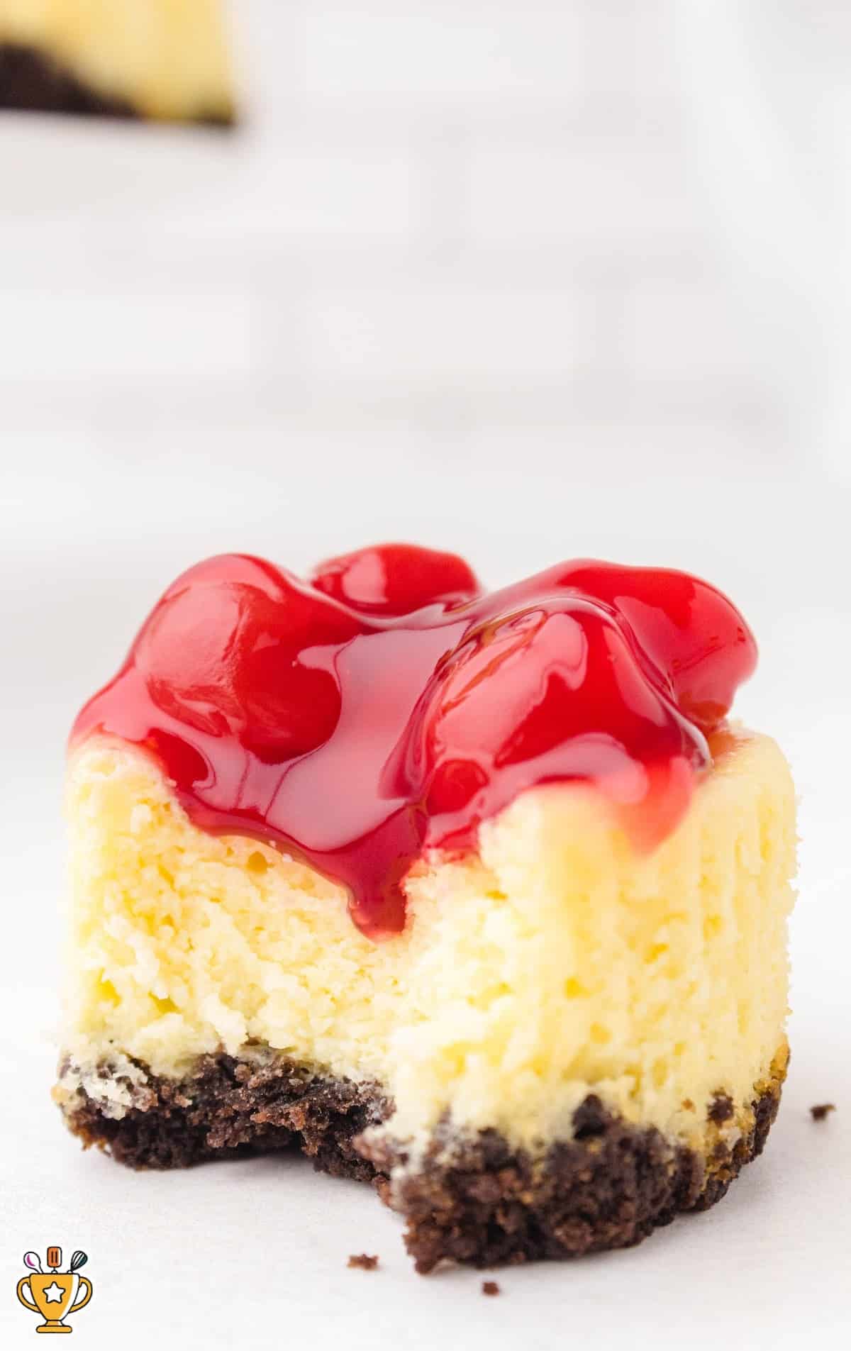 a Mini Cherry Cheesecake with a bite on it