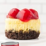 a Mini Cherry Cheesecake on a cake stand