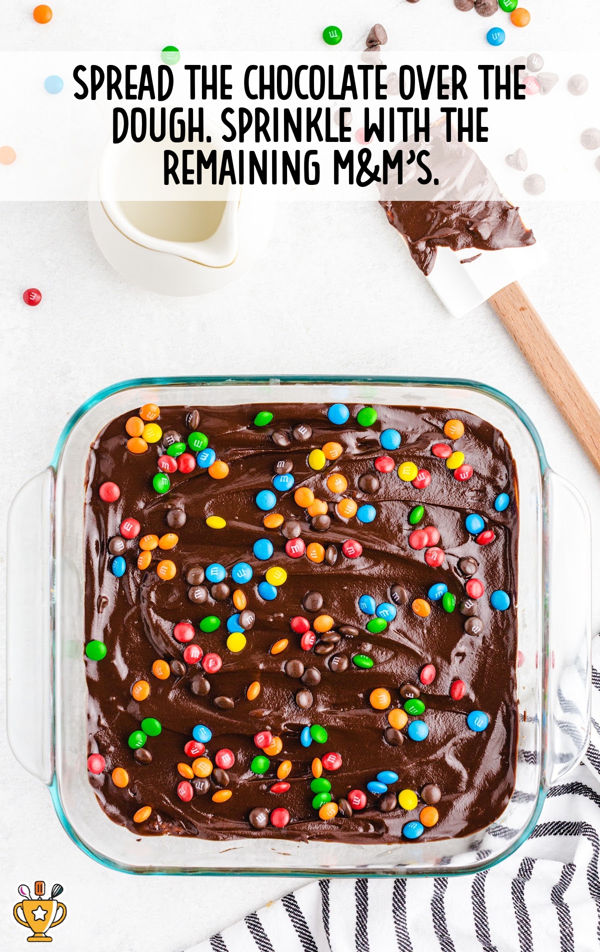 chocolate spread over the dough with m&m's sprinkles