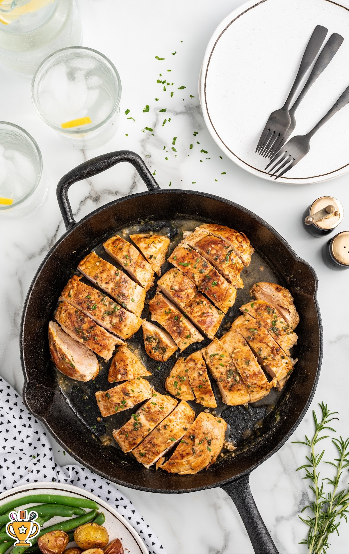 Pan Seared Chicken in a skillet and a plate with forks on the side