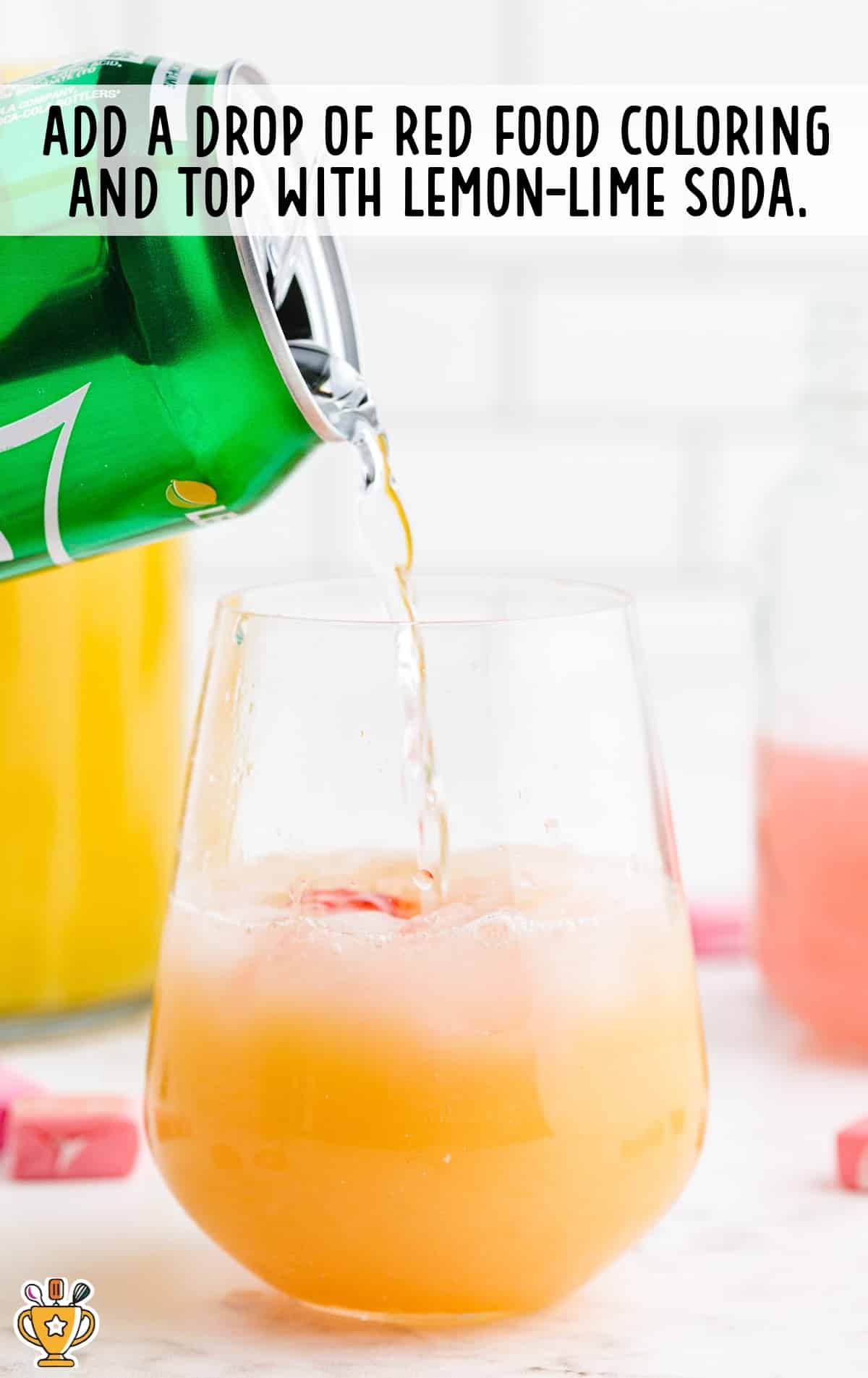 pouring lemon lime soda into Pink Starburst Cocktail glass