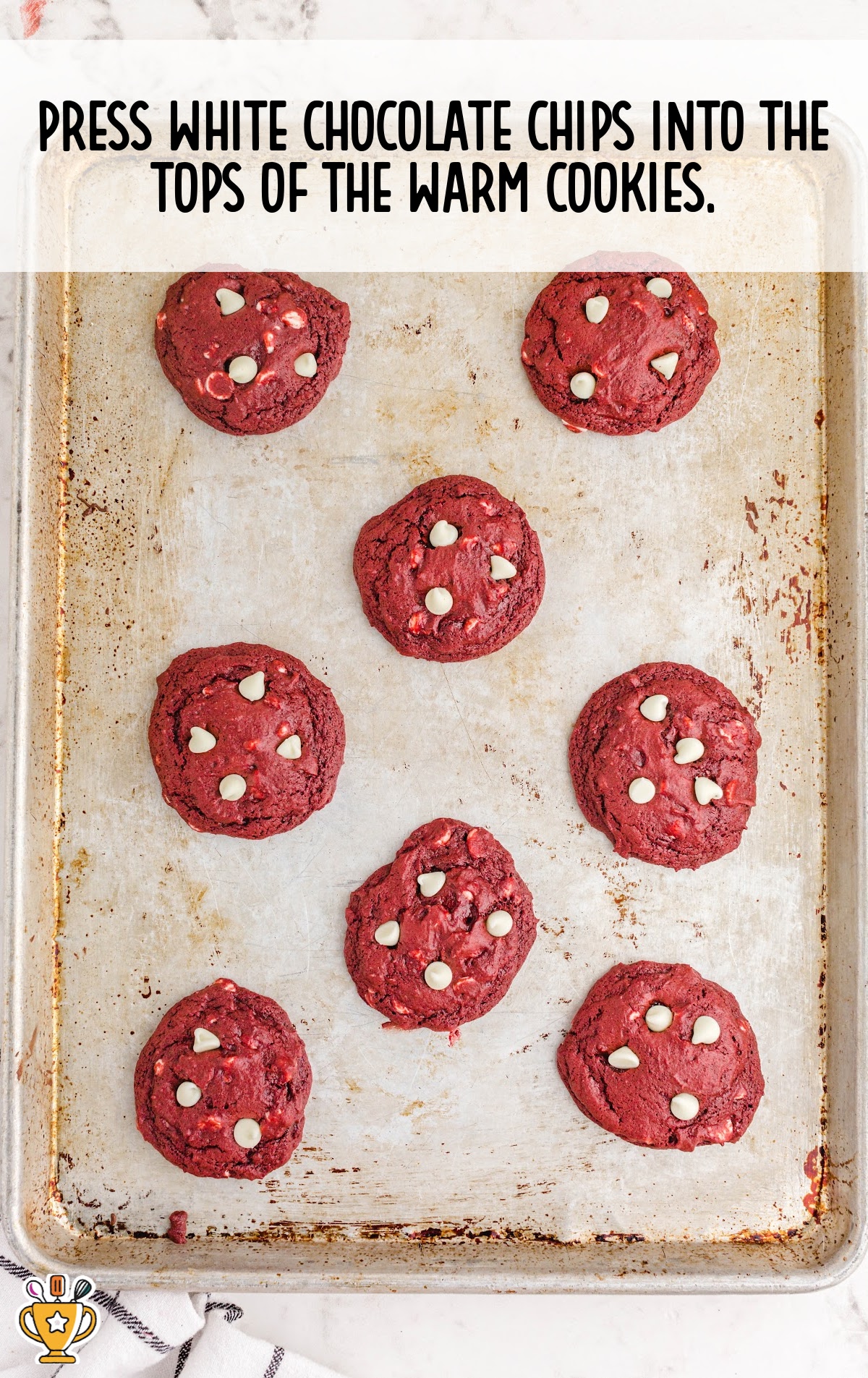 pressing white chocolate chips into the tops of warm cookies