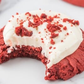 a Red Velvet Cream Cheese Cookie with a bite on it