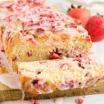 Strawberry Bread with one cut piece on a wooden board