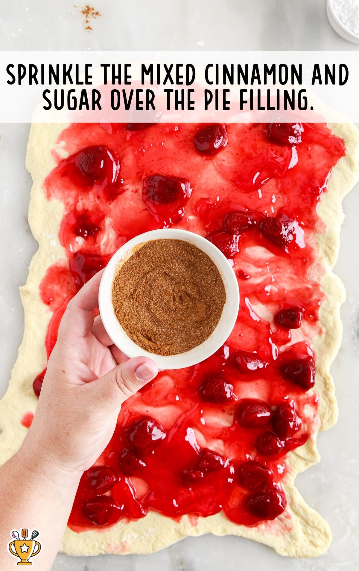 sprinkling mixed cinnamon and sugar over the pie filling