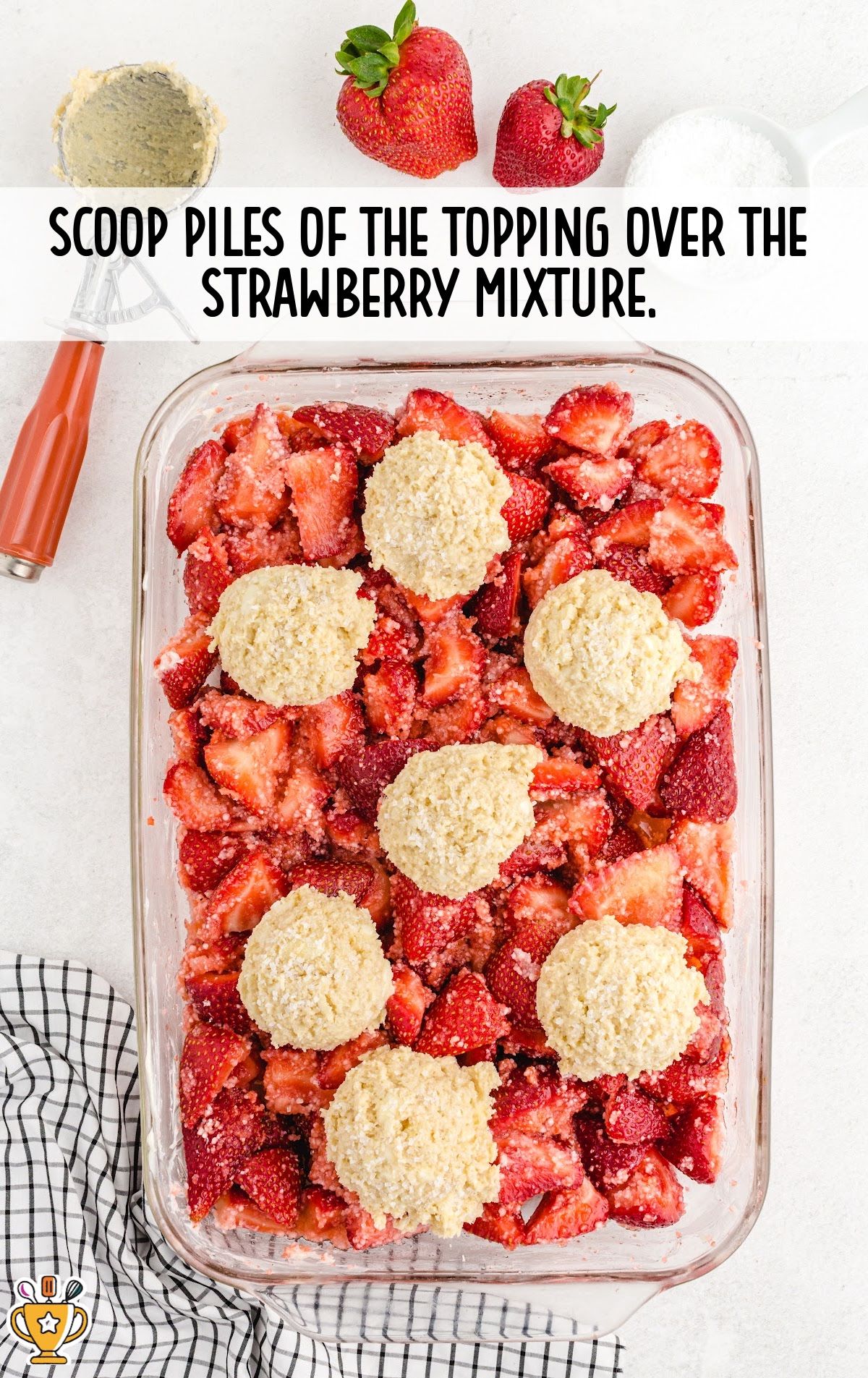piles of the topping over strawberry mixture in a baking dish