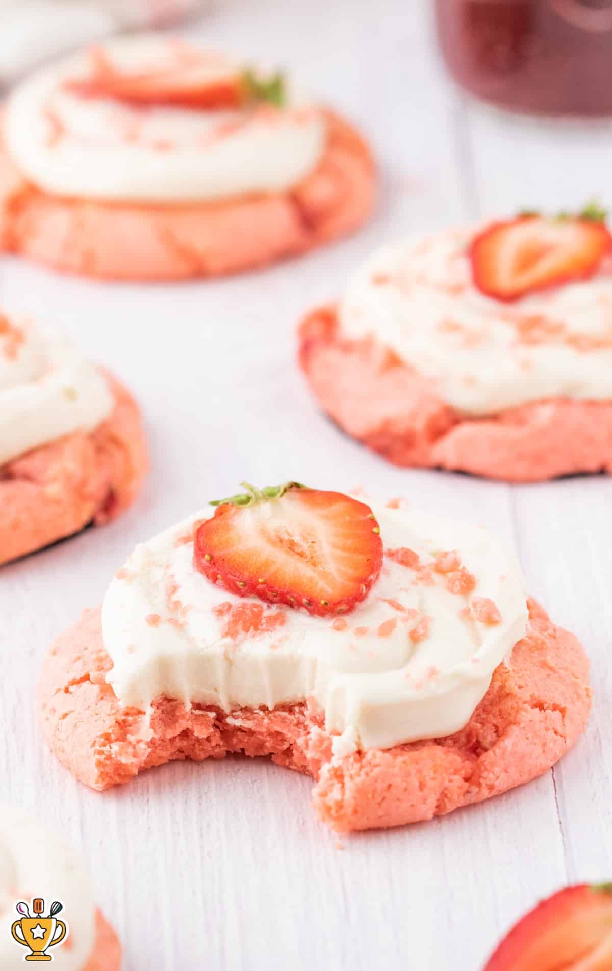 a Strawberry Cookie with Cream Cheese Frosting with a bunch others at the back