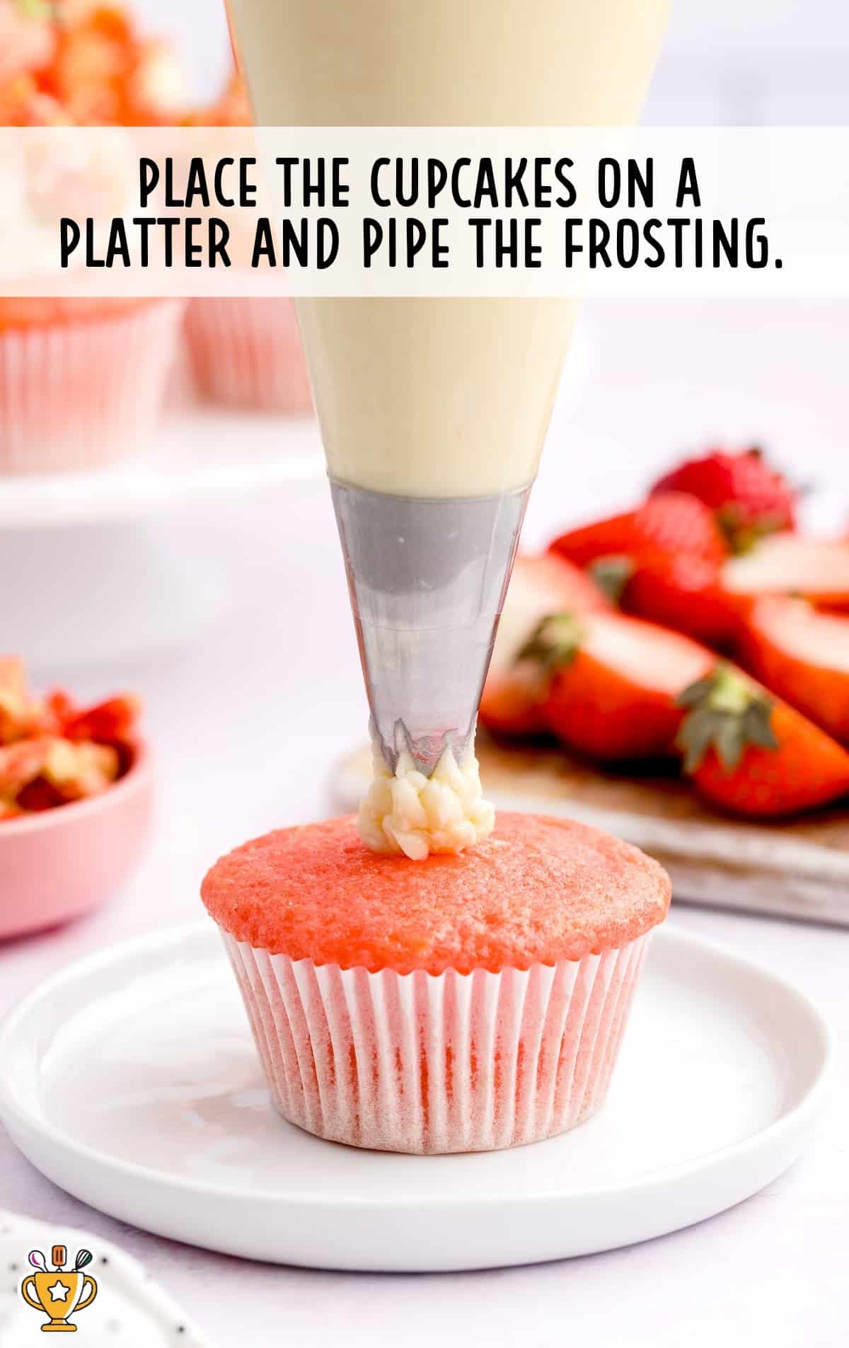 cupcake placed on a platter, piping the frosting on top