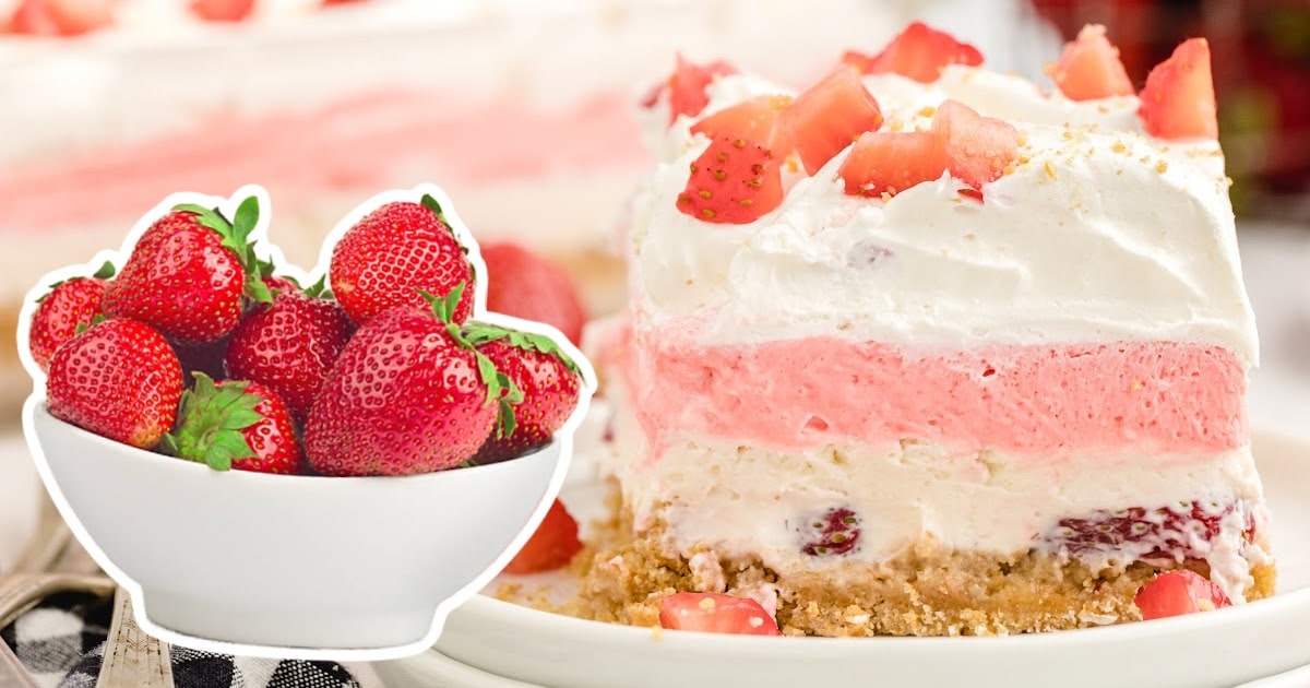 a piece of Strawberry Delight on a plate and a bowl full of strawberry on the side