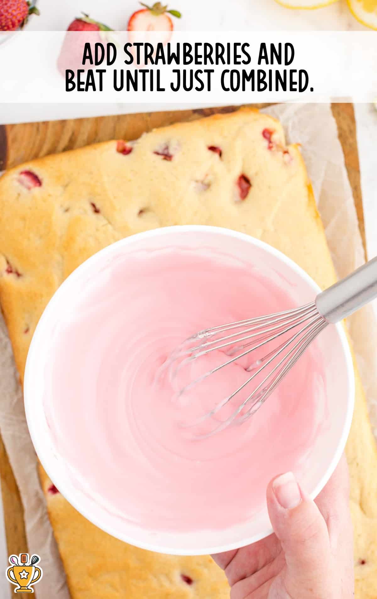 strawberries added in a bowl with a whisker