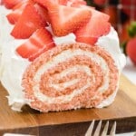 a Strawberry Roll Cake on a wooden board